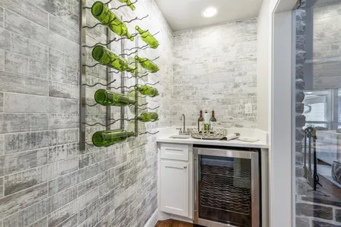 a utility room with a sink and a mirror
