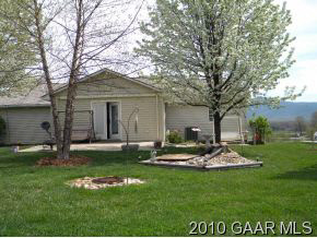 66 Spottswood Road Raphine, VA 24472 - Photo 2 of 12 a front view of a house with a garden and trees