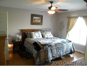 66 Spottswood Road Raphine, VA 24472 - Photo 4 of 12 a bed sitting in a bedroom next to a window
