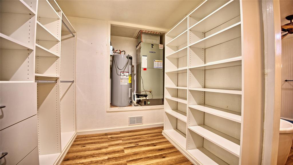 584 West Alamo Road Bowie, TX 76230 - Photo 14 of 40 a view of a bedroom with wooden floor and windows