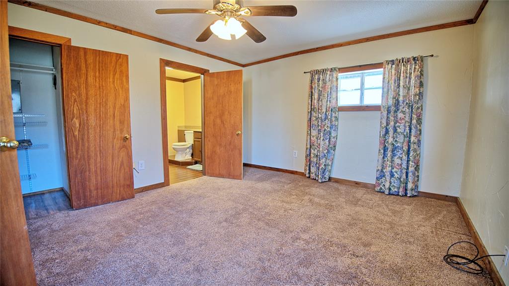 584 West Alamo Road Bowie, TX 76230 - Photo 18 of 40 wooden floor and windows in a room