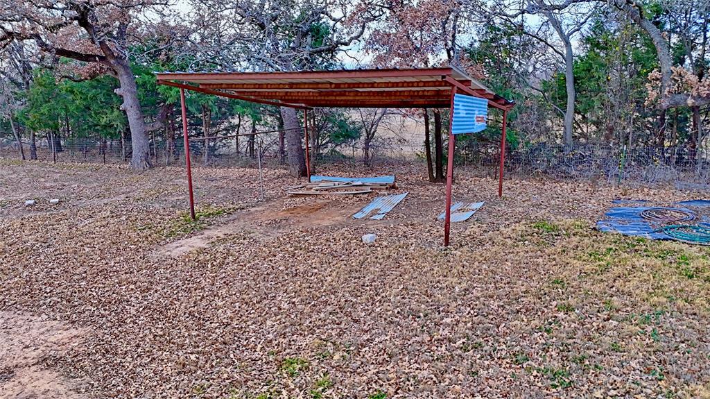 584 West Alamo Road Bowie, TX 76230 - Photo 25 of 40 a backyard of a house with table and chairs