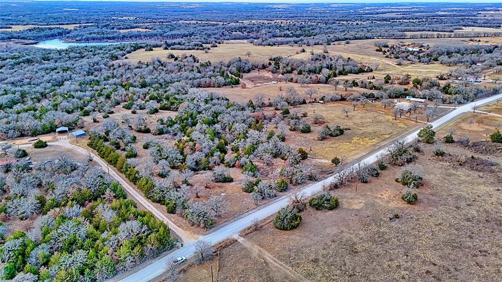 584 West Alamo Road Bowie, TX 76230 - Photo 36 of 40 an aerial view of a forest with a beach
