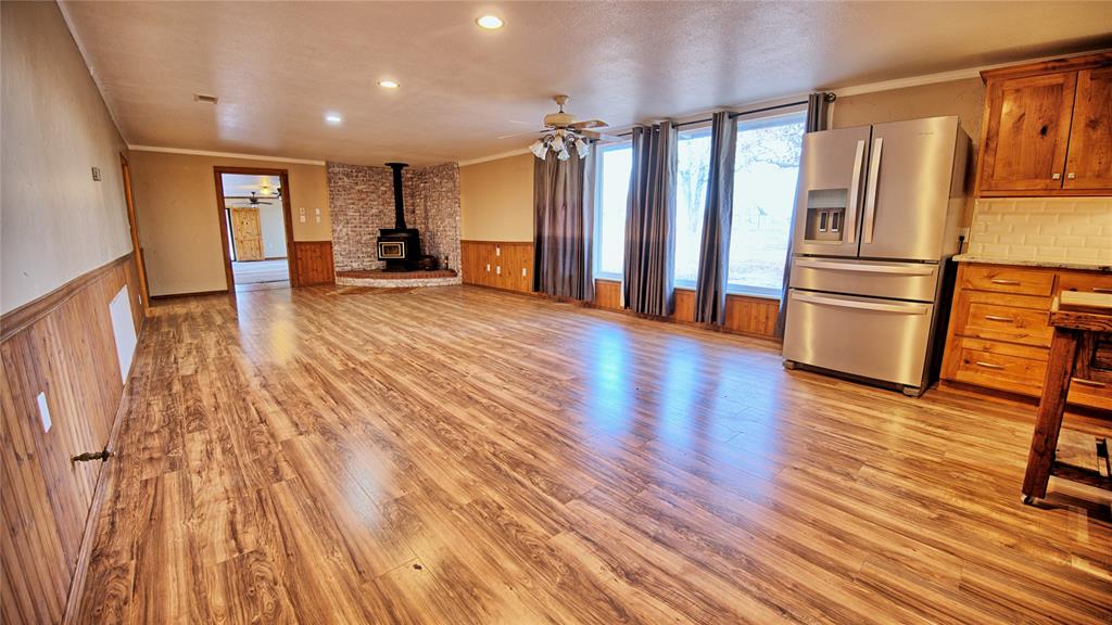 584 West Alamo Road Bowie, TX 76230 - Photo 4 of 40 a view of a kitchen with wooden floor and electronic appliances