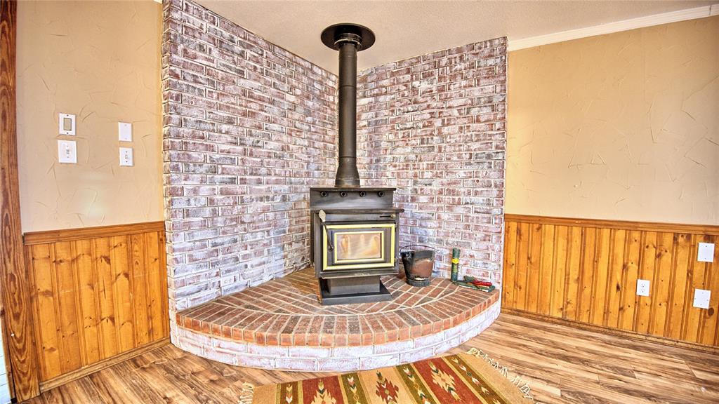 584 West Alamo Road Bowie, TX 76230 - Photo 5 of 40 a view of a fireplace in the balcony