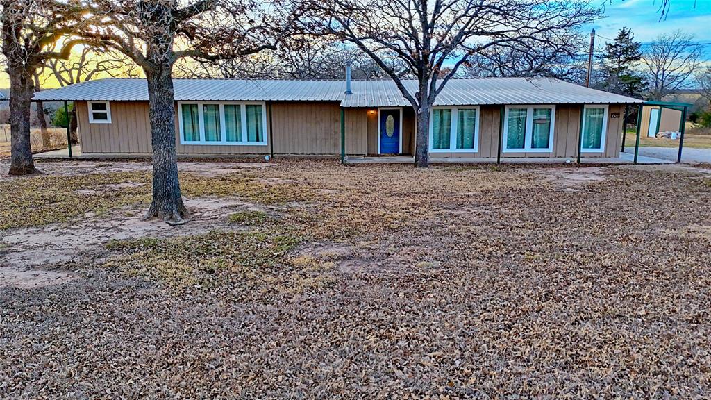 584 West Alamo Road Bowie, TX 76230 - Photo 8 of 40 a front view of a house with a garden