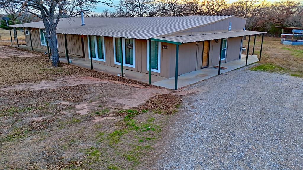 584 West Alamo Road Bowie, TX 76230 - Photo 9 of 40 a view of house with backyard and entertaining space