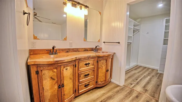 a view of a bedroom with wooden floor and windows