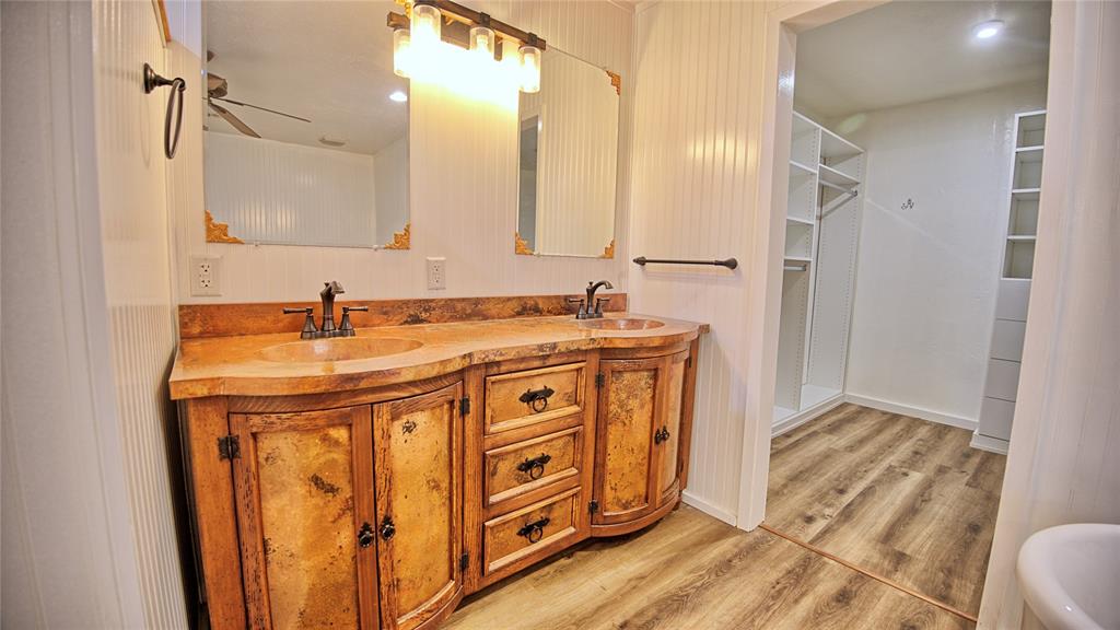 584 West Alamo Road Bowie, TX 76230 - Photo 10 of 40 a bathroom with a sink a mirror and a shower