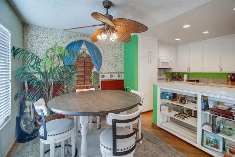 a kitchen with stainless steel appliances granite countertop a stove a sink and a dining table