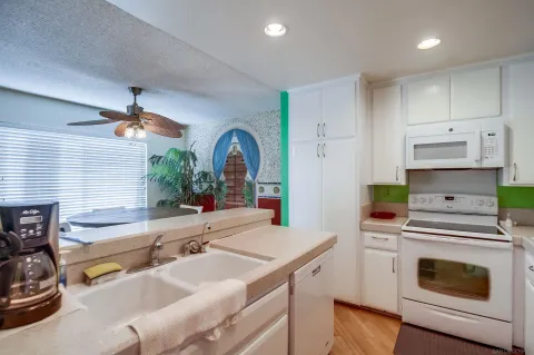 a kitchen with a sink stove and cabinets