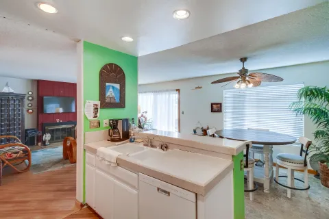 a kitchen with a sink a table and chairs