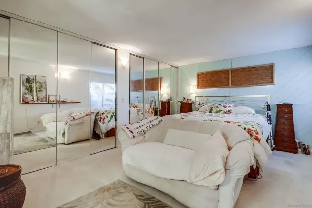 a bedroom with a bed a table and chair