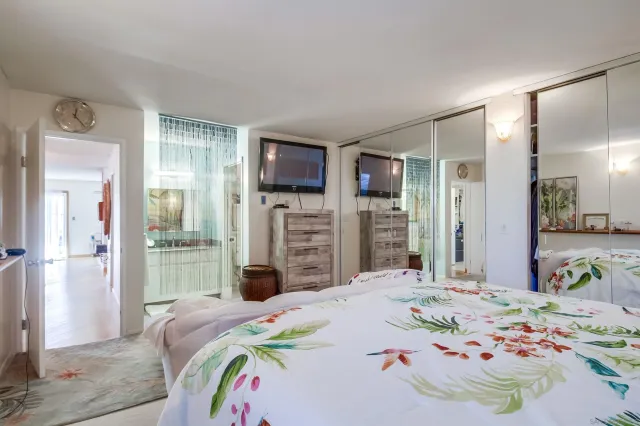 a bedroom with a bed and a flat screen tv