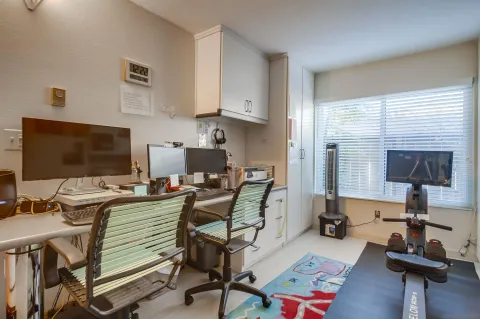 a work room with furniture and a flat screen tv