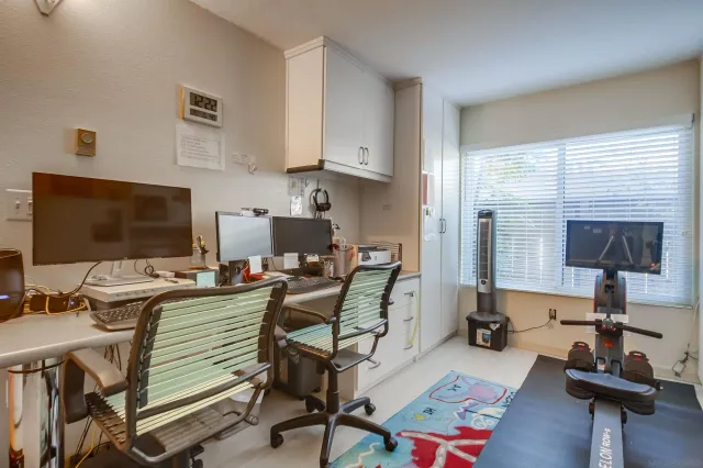 a work room with furniture and a flat screen tv