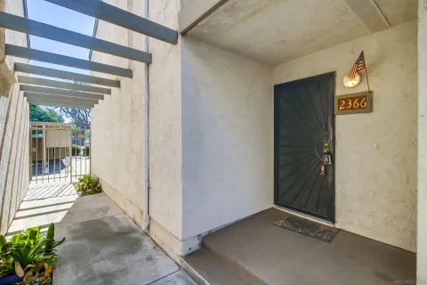 a view of a hallway with wooden door