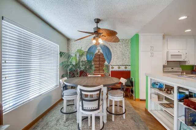 a dining room with furniture and window