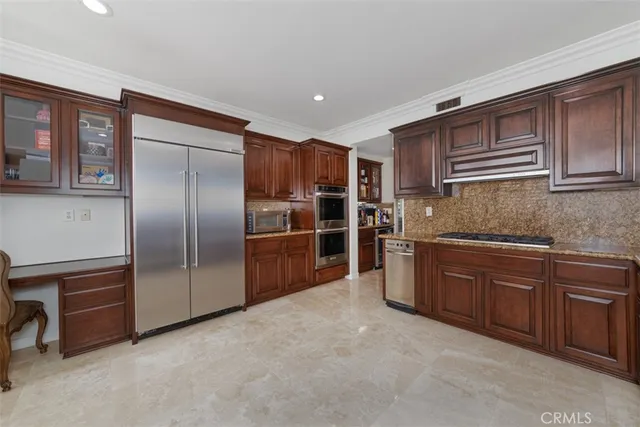 a kitchen with stainless steel appliances granite countertop a refrigerator and a sink