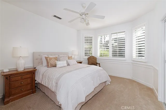 a spacious bedroom with a bed and a couch