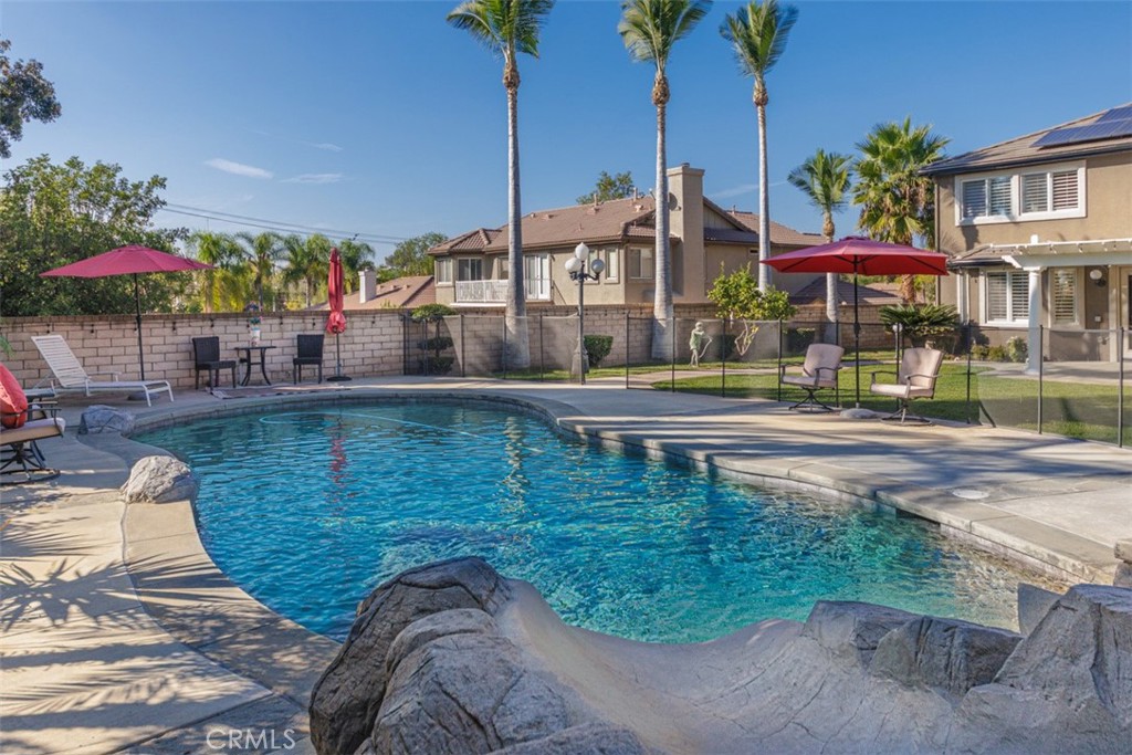 17722 Neff Ranch Road Yorba Linda, CA 92886 - Photo 38 of 63 Sparkling pool with a rock slide, waterfall, and spa, perfect for outdoor fun and relaxation.