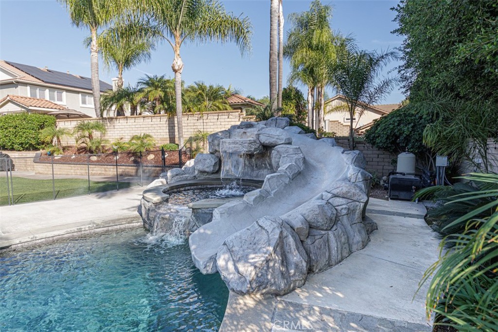17722 Neff Ranch Road Yorba Linda, CA 92886 - Photo 39 of 63 A rock waterfall and slide add a touch of resort luxury to the backyard, creating a space that’s as lively as it is relaxing.