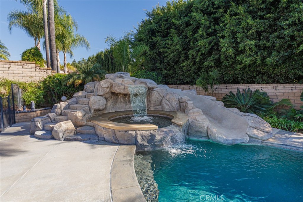 17722 Neff Ranch Road Yorba Linda, CA 92886 - Photo 41 of 63 a view of a backyard with table and chairs potted plants and palm tree