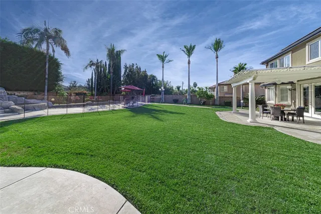 a view of a patio with a dining table and chairs