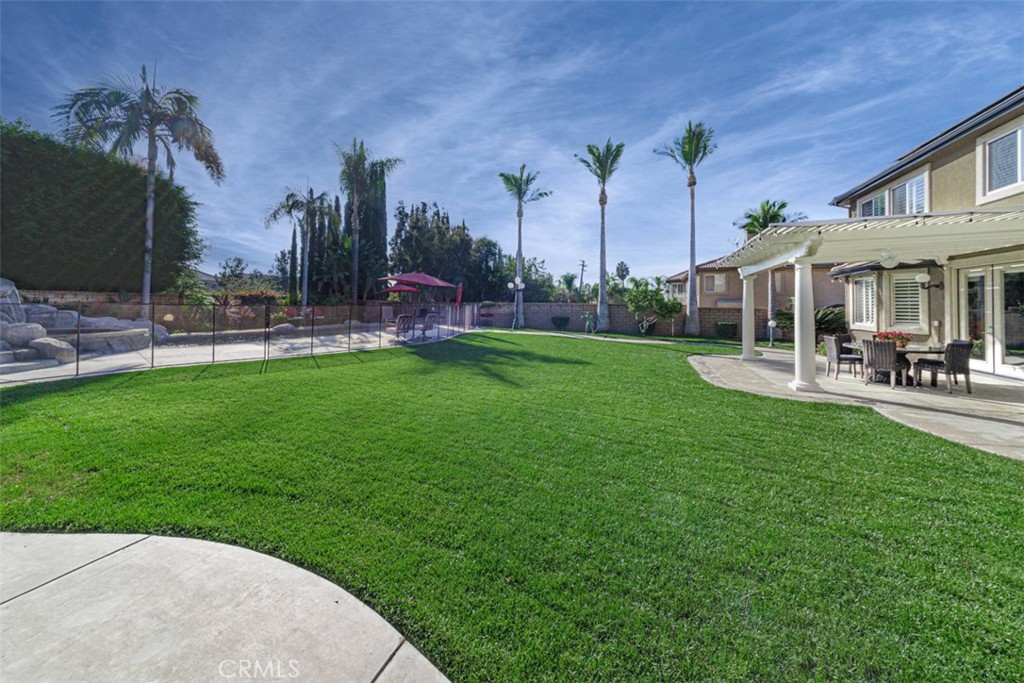 17722 Neff Ranch Road Yorba Linda, CA 92886 - Photo 42 of 63 a view of a patio with table and chairs potted plants and a big yard