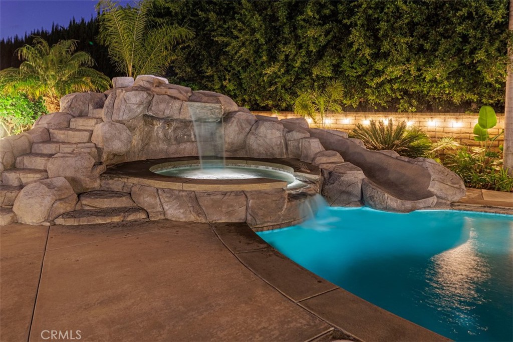 17722 Neff Ranch Road Yorba Linda, CA 92886 - Photo 52 of 63 a view of a backyard with lawn chairs under an umbrella
