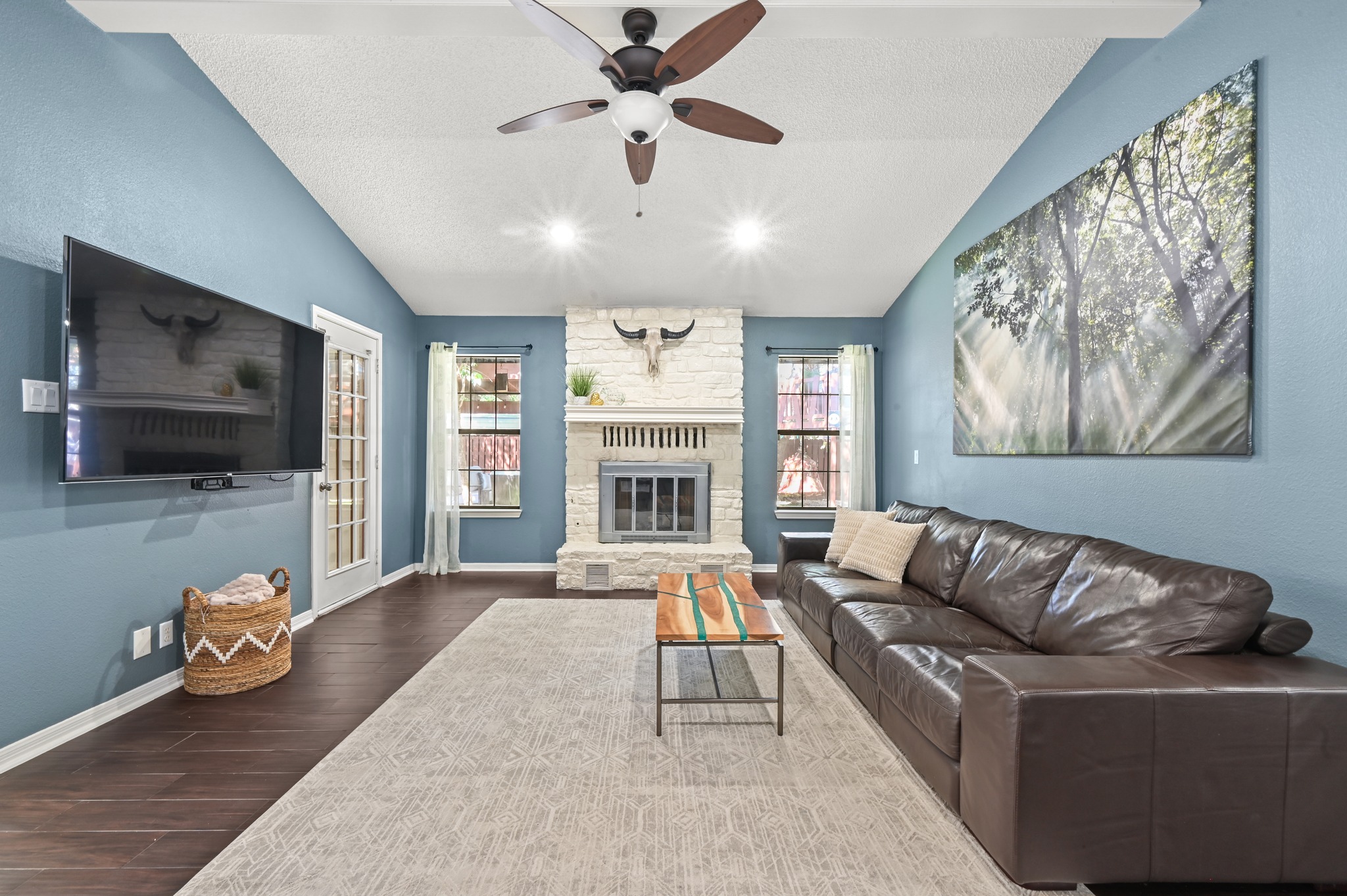 303 Pin Oak Drive Georgetown, TX 78628 - Photo 9 of 36 a living room with furniture flat screen tv and a fireplace