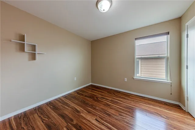 a view of a room with wooden floor and windows