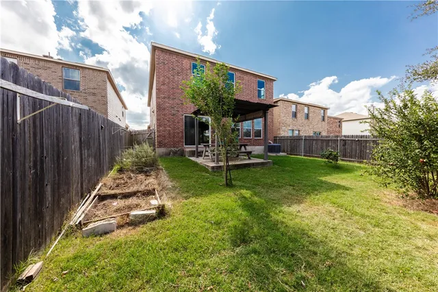 a view of a house with backyard and porch