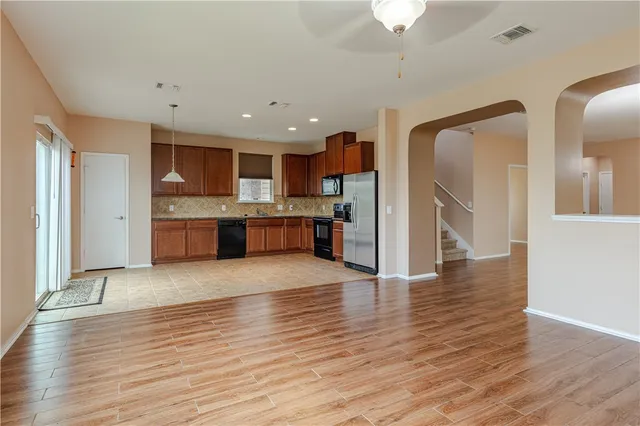 a view of a kitchen with a sink and a refrigerator