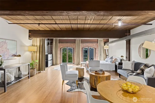a living room with fireplace furniture and a large window
