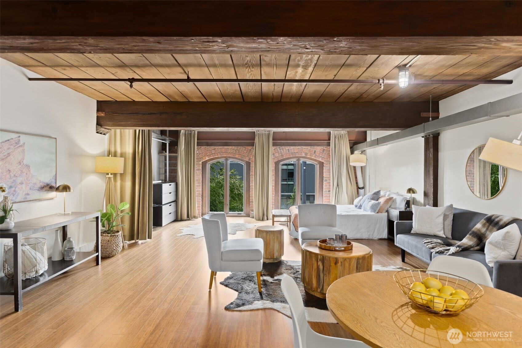 a living room with fireplace furniture and a large window