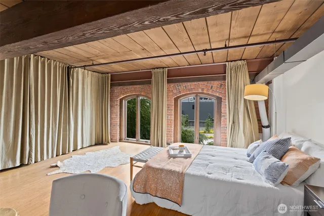 a bedroom with a bed and a large window
