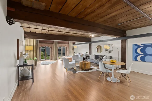 a living room with patio furniture and a wooden floor