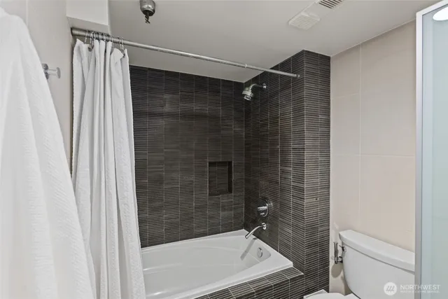 a bathroom with a shower and a toilet