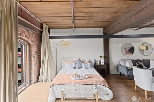 a bedroom with a bed a mirror and dresser