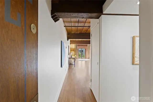 a view of a hallway with wooden floor