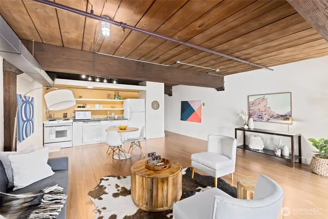 a living room with furniture and a kitchen view