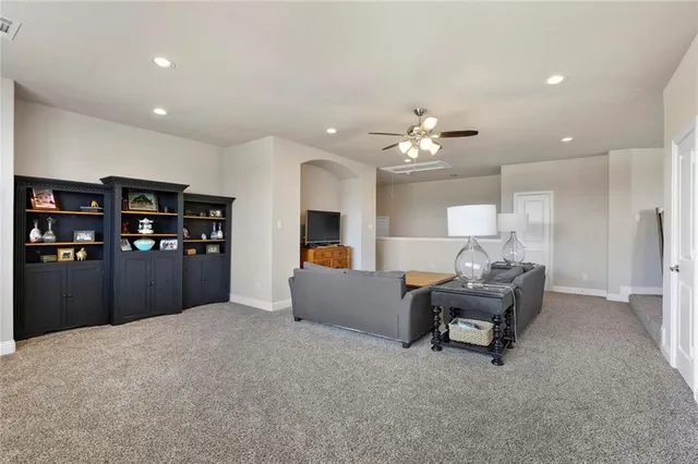 a living room with furniture a chandelier and a dining room