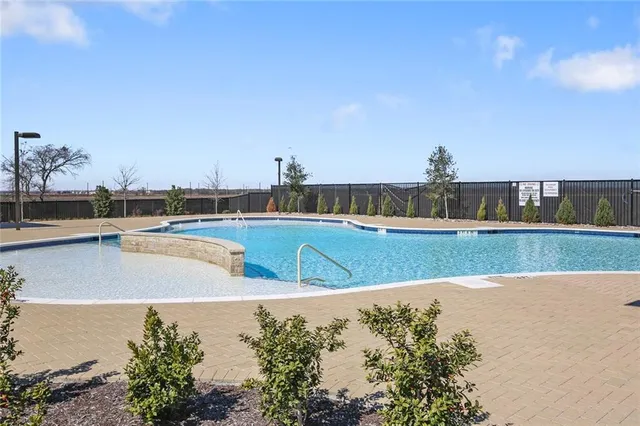 a view of a swimming pool and a yard