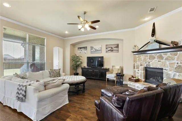 a living room with furniture and a fireplace