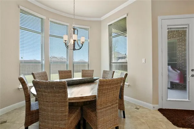 a dining room with furniture and windows