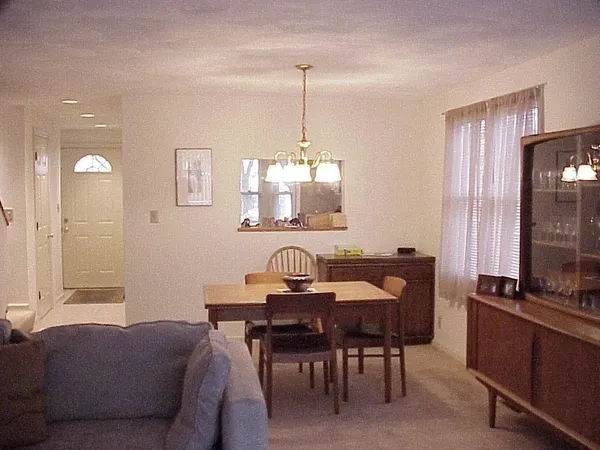 a dining room with furniture and window