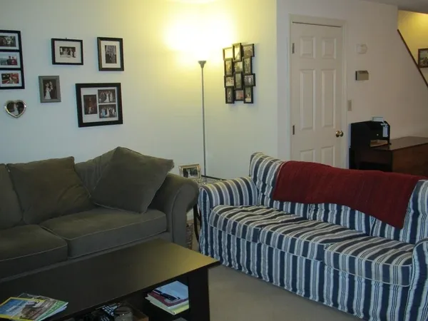 a living room with furniture and a lamp