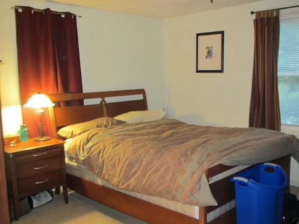 a bedroom with a bed and a window