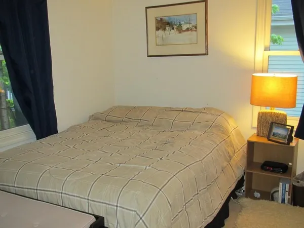 a bedroom with a bed and a workspace